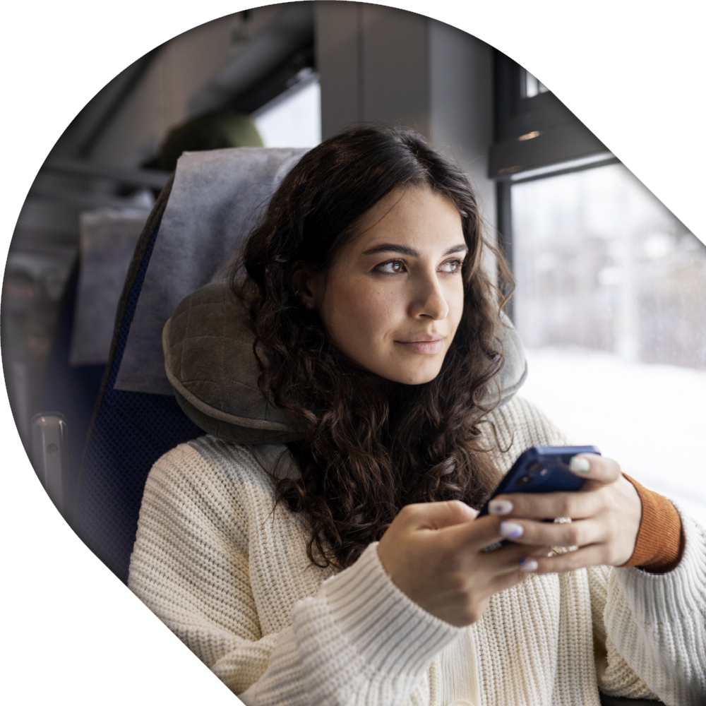 Eine junge Frau sitzt in einem Reisebus.